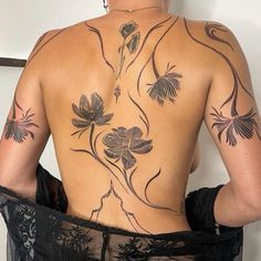 the back of a woman with tattoos on her body