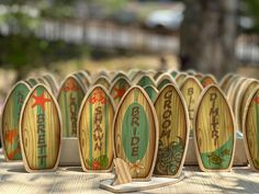 wooden surfboards are lined up on a table