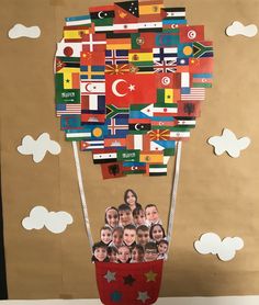 a hot air balloon made out of many different countries and flags with pictures of people in it