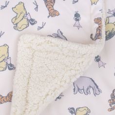 a white blanket with winnie the pooh characters on it