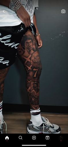 a man with tattoos on his legs and leggings