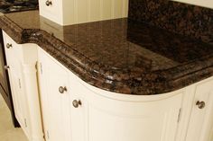 a marble counter top in a kitchen with white cabinets