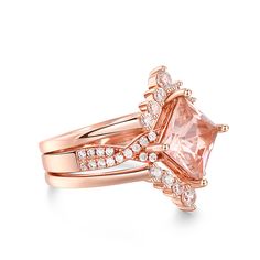 Celebrate your journey of love with this exquisite set, and let its timeless beauty be a reflection of your everlasting commitment. This exquisite ring showcases a mesmerizing princess-cut morganite as its centerpiece, capturing attention with its radiant beauty. The ring's design is a true masterpiece, with a twist motif adorning the ring shank, symbolizing the intertwining of two souls on their journey of love. The intricate details and delicate craftsmanship make this piece a true work of art, blending timeless charm with contemporary flair. Completing the set is two matching bands, perfectly complementing the engagement ring and enhancing its overall splendor. Together, they create a harmonious symphony of beauty and elegance, symbolizing the unity and everlasting bond between two hear Luxury Topaz Ring With Asscher Cut For Weddings, Luxury Asscher Cut Topaz Ring For Wedding, Fine Jewelry Bridal Sets Princess Cut, Luxury Rose Gold Topaz Ring For Wedding, Luxury Asscher Cut Topaz Wedding Ring, Princess Cut Jewelry With Accent Stones, Princess Cut Bridal Sets Fine Jewelry Gift, Princess Cut Bridal Sets For Gift, Princess Cut Bridal Set With Center Stone