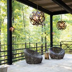 two wicker chairs sitting on top of a wooden deck