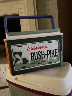 a license plate on top of a cooler