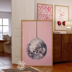 there is a mirror ball hanging on the wall next to a dresser and other decor