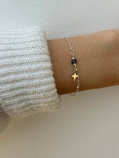 This little bracelet featuring a gemstone/birthstone and tiny cross makes a great gift for someone special or yourself. D E T A I L S *Made with a high quality chain available in 14k gold filled, rose gold filled and sterling silver. *And beautiful gemstone that has been wire wrapped to the chain. These are genuine high quality gemstone crystals measuring between 3 and 4mm.  *a tiny gold filled/sterling silver cross hangs down adding a pretty accent. *Length: Choose the length you prefer from the drop down menu. A snug fit works best for a chain bracelet so use the length chart as a reference. *Bracelet comes with an information card and is ready for gifting. C A R E * T I P  This is a dainty bracelet so please treat it with care. Avoid contact with water, perfume and chemicals. Also remov Sterling Silver Spiritual Rosary Bracelet With Cross, Sterling Silver Cross Rosary Bracelet, Spiritual Sterling Silver Cross Rosary Bracelet, Dainty Sterling Silver Cross Bracelet, Silver Bracelet With Cross Pendant As Gift, Nickel Free Sterling Silver Cross Bracelets, Nickel-free Cross Bracelet Gift, Spiritual Cross Charm Bracelet Gift, Dainty Hypoallergenic Rosary Bracelet Gift