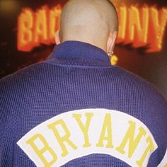 the back of a baseball player's jersey that is purple with yellow and white letters