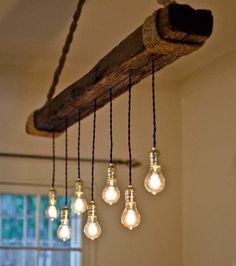 some light bulbs hanging from a wooden beam