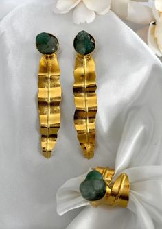 The elegant design, fashion style of the Cata earrings will make you feel more charming. They are lightweight, comfortable for day and night. You'll find these will be your new favorite earrings. DETAILS - Material: 24k gold plated bronze and raw emerald - Weight: 6 gr - Keep it away from water, sweat, perfumes and lotions. - Store your jewelry in their original packaging or a soft pouch. Gold Emerald Earrings For Gift, Elegant Green Hammered Earrings, Elegant Gold Emerald Earrings, Gold Emerald Dangle Earrings, Lotus Earrings, Raw Emerald, Day And Night, Design Fashion, Artisan Jewelry