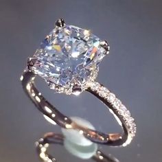 an engagement ring with a cushion cut diamond