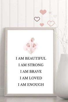 a white framed print with the words i am beautiful, i am strong and i am loved