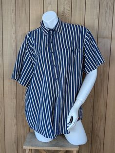 Found! 🔎 Vintage navy and white vertical striped short sleeved men's button up shirt in durable cotton. Large front pockets and nice fade to fabric for vintage vibes. This shirt is in excellent vintage condition with no noticeable defects. Made by LineUp - a workwear line? Size 100cm chest vintage (suit M-XL modern depending on fit).  👗 Measurements:  - 79cm length  - 48cm shoulder  - 60.5cm chest ------------------------------  - All measurements approximate. Please compare to clothing you ow Relaxed Fit Short Sleeve Cotton Shirt With Vertical Stripes, Striped Cotton Short Sleeve Shirt, Striped Collared Shirt With Pockets, Striped Cotton Camp Shirt With Short Sleeves, Striped Collared Short Sleeve Cotton Shirt, Striped Cotton Collared Short Sleeve Shirt, Striped Short Sleeve Shirt With Pockets, Striped Collared Short Sleeve Shirt With Button Closure, Pinstripe Collared Shirt With Pockets