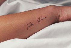 a person with a tattoo on their arm that says, take peace in cursive writing