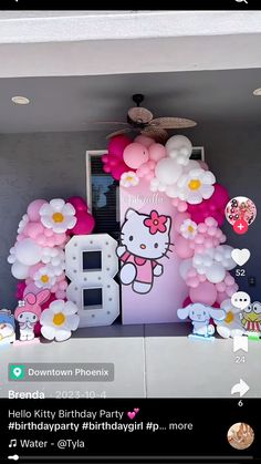 a hello kitty birthday party with balloons and flowers on the front door, including an 8 balloon arch