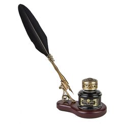 a pen and quill sitting on top of a desk