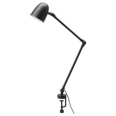 a black desk lamp on a white background with clippings to the side and one arm pointing up