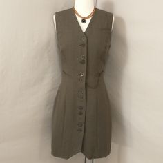 90's Vintage Button Front Sleeveless Jumper - Long Gillet Vest. Brown Herringbone Wool Fabric, Bronze Buttons And Pocket Chain. Marked Size 40, Shown On A 2 Dress Form Please Go By Measurements. Length 36" In Front At Point, 34.5" In Back, Shoulders 16", Pit To Pit 17", Waist 27", Hips 36". Condition Very Good, Looks Unworn But One Flaw - See Last Two Pics Including Close Up Pic. Versatile Piece, Great For Layering. Nice Example Of Italian Quality And Designer Panache. Timeless, Classic. Fitted Khaki Vest For Work, Retro Fitted Vest With Button Closure, Fitted Retro Vest With Button Closure, Retro Fitted Sleeveless Vest, Vintage Summer Vest For Workwear, 90s Vest, Pocket Chain, Sleeveless Jumper, Long Vest