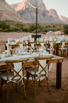 a table set up for an outdoor dinner in the desert