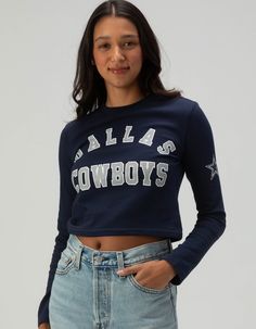 Dallas Cowboys Long Sleeve Baby Tee. Show Your Team Pride With This Dallas Cowboys Long Sleeve Baby Tee. Featuring "dallas Cowboys" Screened Across The Front Chest And A Bold Star Graphic On The Left Sleeve, This Fitted Tee Is Perfect For Fans Looking For A Stylish And Sporty Look. Ideal For Game Day Or Casual Wear! 94% Cotton, 6% Spandex. Machine Wash. Imported. Model Is Wearing A Size Small. Model Measurements:height: 5'8" Bust: 32"waist: 24"hips: 35" Blue Fitted Tops For College, Game Day Long Sleeve Top With Graphic Print, Game Day Long Sleeve Graphic Print Top, Blue Tops For Spring School Spirit, Blue Spring Tops For School Spirit, Blue Spring Tops With School Spirit Style, Collegiate Style Fitted Tops For Spring, School Spirit Fall Tops With Letter Print, School Spirit Tops With Letter Print For Fall