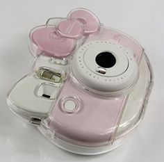 a pink and white camera sitting on top of a table