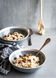 two bowls filled with oatmeal and raisins