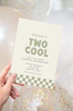 a person holding up a card that says hudson is two cool