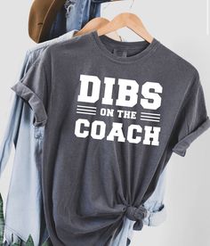 Dibs on the coach! This is a unisex short sleeve T-shirt in grey! The image on the shirt is made from red, white or black vinyl! Care instructions will be included with your package! These shirts will last! You will have the option to choose the color vinyl and size at checkout. If you have any questions or would like to change anything on the shirt please send me a message! Dibs On The Coach Shirt, Football Coach Wife, Coaches Wife Shirt, Dibs On The Coach, Cheer Coach Shirts, Coaches Wife, Wife Tshirts, Dance Coach, Coach Shirt