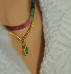 "18K Gold Emerald Pendant Set with gemstones Bead unique necklace. The pendant: 18k yellow gold oval pendant with oval green Emerald stone and 7 small Ruby stones set aside. **  18k yellow gold **  7 small 1.1 Ruby stones **  Oval 7 * 5 Emerald stone  **  Two large gold links 0.8 - 0.9 m\"m The handmade unique gold pendant that I made especially for this green oval Emerald.  On the side of the pendant, I set 7 red Ruby that makes this pendant even more beautiful and special. The oval emerald is set in a unique setting with gold dots all around. The Small Ruby stones on the side of the pendant are set with small circles around. The pendant has an antique-style look.                                                      The gemstone necklace is Emerald, Ruby and Sapphires beads necklace. The Yellow Gold Multi-stone Oval Pendant Jewelry, Oval Emerald Necklace With Natural Stones For Gift, Elegant Oval Emerald Necklace With Natural Stones, Handmade Oval Gold Gemstones, Luxury Oval Gemstone Beads Jewelry, Oval Emerald Gemstone Necklace In Yellow Gold, Gold Multi-stone Oval Pendant Jewelry, Gold Emerald Rondelle Necklace, Handmade Yellow Gold Necklace With Oval Cabochon