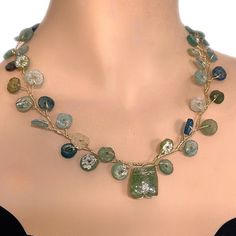 Triumph in elegance is ready: Handmade  Necklace of Victory Werath with Ancient Roman Glass  A captivating Roman glass necklace, a piece of ancient elegance meticulously crafted into a stunning garland in varying shades of blue and green. Immerse yourself in the allure of history with this unique and timeless accessory. This stunning  vine necklace is made of ancient Roman glass round pieces woven with 14K gold filled wire to a beautiful vine with an interesting shred in the center. The necklace Elegant Green Glass Necklaces, Delicate Handmade Jewelry For Celebrations, Handmade Delicate Jewelry For Celebrations, Elegant Gold Beaded Necklaces Wire Wrapped, Elegant Gold Beaded Necklace With Wire Wrapped Detail, Elegant Gold Wire Wrapped Beaded Necklace, Gold Wire Wrapped Glass Necklaces, Gold Wire Wrapped Jewelry For Festive Occasions, Elegant Gold Beaded Emerald Necklace