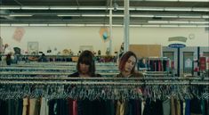 two women looking at clothes in a store