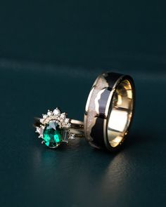 two wedding rings with green and white stones