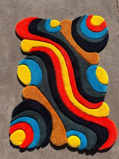 a multicolored area rug on the ground