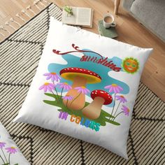 two pillows on the floor with flowers and mushrooms