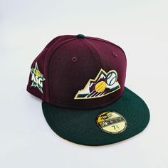 the minnesota stars snap back hat is maroon and green