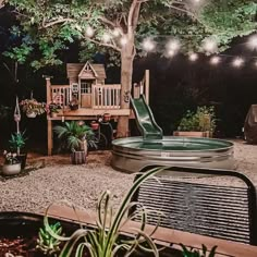 an outdoor play area with a slide and lights