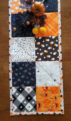 an orange and black patchwork halloween themed table runner