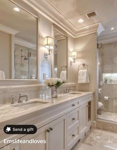 a large bathroom with two sinks and a walk in shower