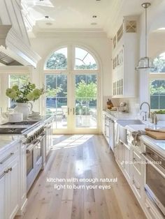 a large kitchen with white cabinets and wood flooring is featured in the magazine's latest issue