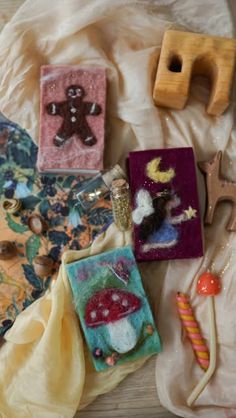 various items are laying out on the bed together, including magnets and other decorations