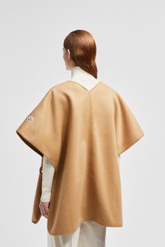 Easily worn alone in milder weather or layered over other pieces, this cape is crafted from a wool and nylon blend. The accessory features a V-neck silhouette, adding a feminine note to the design. Luxury Wool Cape For Winter, Luxury Wool Winter Cape, Wool Poncho For Workwear, Beige Wool Cape Outerwear, Personalized Jacket, Cashmere Cape, Jacket Cape, Black Wool Coat, Wool Cape