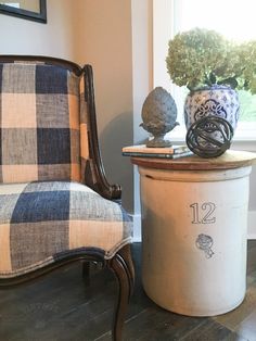 a chair sitting next to a table with a potted plant on top of it