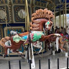 an old fashioned merry go round with horses on it