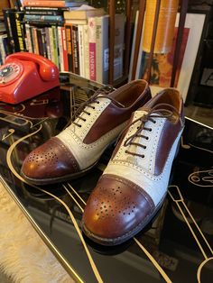 "Amazing pair of late 1960s psychedelic freakbeat era Charles Horrell platform heel two tone brogue shoes. Circa 1967 I would say,after the flat shoes/boots of the early 60s things started to get a bit funky in the late 60s with the sartorial suits having more of a cut,flare so the heels had to be slightly bigger,I wouldn't necessarily call these platform shoes but they have a 2&1/4\" inch heel which is pretty special. I owned these for possibly 10-12 years or so and that is me pictured wearing them,great with a turn up flare or with bags as pictured. Steve Marriott from the Small faces had a similar pair with a heel which is why I kept them,time to let them go although I may regret it. White leather will obviously show its age,a bit of a touch up maybe to make them look even better/freshe Retro Brogue Oxfords For Derby, Retro Wingtip Oxfords With Leather Sole, Retro Almond Toe Oxfords For Derby, Retro Brown Almond Toe Oxfords, Vintage Brown Pointed Toe Oxfords, Retro Brown Oxfords, Retro Oxfords With Brogue Detailing And Almond Toe, Retro Oxfords With Brogue Detailing, Retro Oxfords With Brogue Detailing And Round Toe