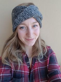 a woman wearing a plaid shirt and a knitted headband