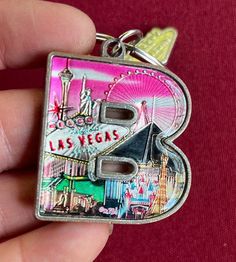 the las vegas key chain is in someone's hand