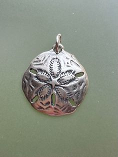 Beautiful sterling silver sand dollar charm, measures 2/3" x 2/3", open sterling silver jump ring included. Great for jewelry making, add ons to knotted necklaces, ocean theme, sea theme, genuine sterling charm. Sea Theme, Ocean Theme, Sand Dollar, Lovely Necklace, Knot Necklace, Add Ons, Gorgeous Necklaces, Jump Rings, How To Make Beads