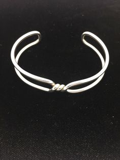 Sterling silver cuff bracelet with three twist center. Looks almost like barbed wire or the wiring of a lightbulb. Unique, minimal design with split band.  KOG# 900077 TES#00249 Silver Cuff Bracelet For Women, Wire Cuff, Barbed Wire, Handmade Wire Jewelry, Sterling Silver Cuff Bracelet, Unique Bracelets, Silver Jewelry Handmade, Wire Bracelet, Sterling Silver Cuff