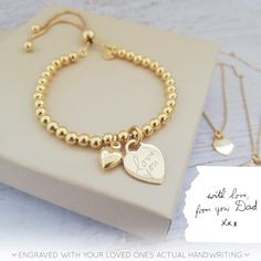 "Our beautiful range of engraved handwriting jewellery makes a beautiful dedication to a loved one, all it takes is a photo of their handwriting for our engraving team to work from. This beautiful yellow gold bracelet combines a yellow gold heart charm, perfect for engraving a name or a short message from a handwriting sample, alongside a dinky yellow gold puffed heart charm. The yellow gold vermeil heart charm measures 12mm across the front of the heart and sits centrally on a yellow gold verme Engraved Round Heart Bracelet For Anniversary, Engraved Round Heart Bracelet As Gift, Engraved Heart Bracelet As Gift, Elegant Engraved Beaded Bracelets As Gift, Engraved Charm Bracelet For Valentine's Day Personalized Gift, Engraved Bracelets For Mother's Day Anniversary, Engraved Bracelet For Anniversary On Mother's Day, Engraved Bracelet For Anniversary And Mother's Day, Adjustable Name Bracelet With Engraved Text For Anniversary