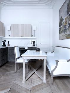 a white table and some chairs in a room